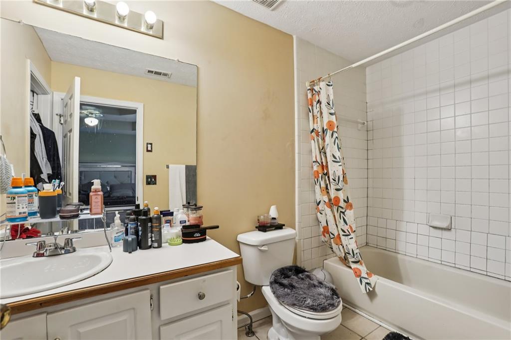 4031 Robin Circle Atlanta, GA 30349 - Photo 12 of 23 a bathroom with a sink a toilet a mirror and shower