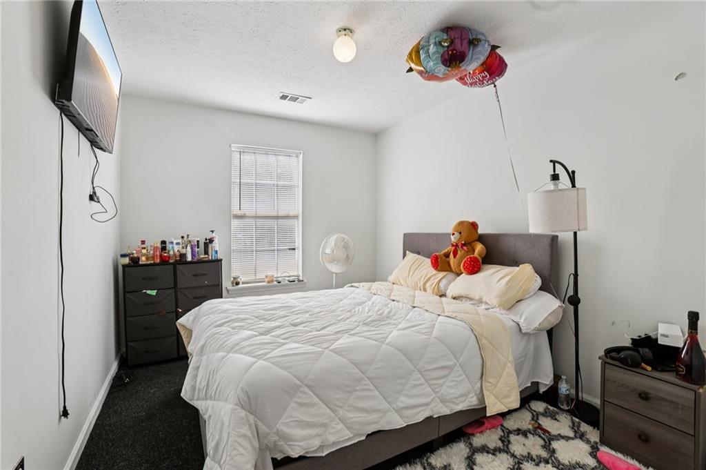 4031 Robin Circle Atlanta, GA 30349 - Photo 13 of 23 a bedroom with a bed and a window