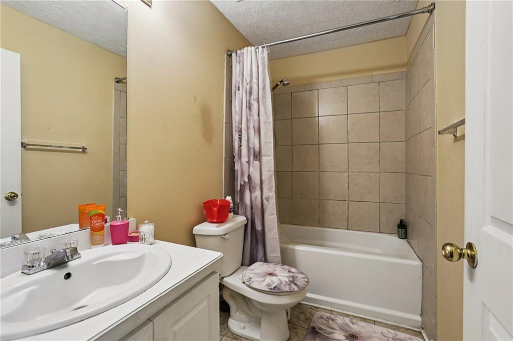 4031 Robin Circle Atlanta, GA 30349 - Photo 15 of 23 a bathroom with a sink toilet and shower