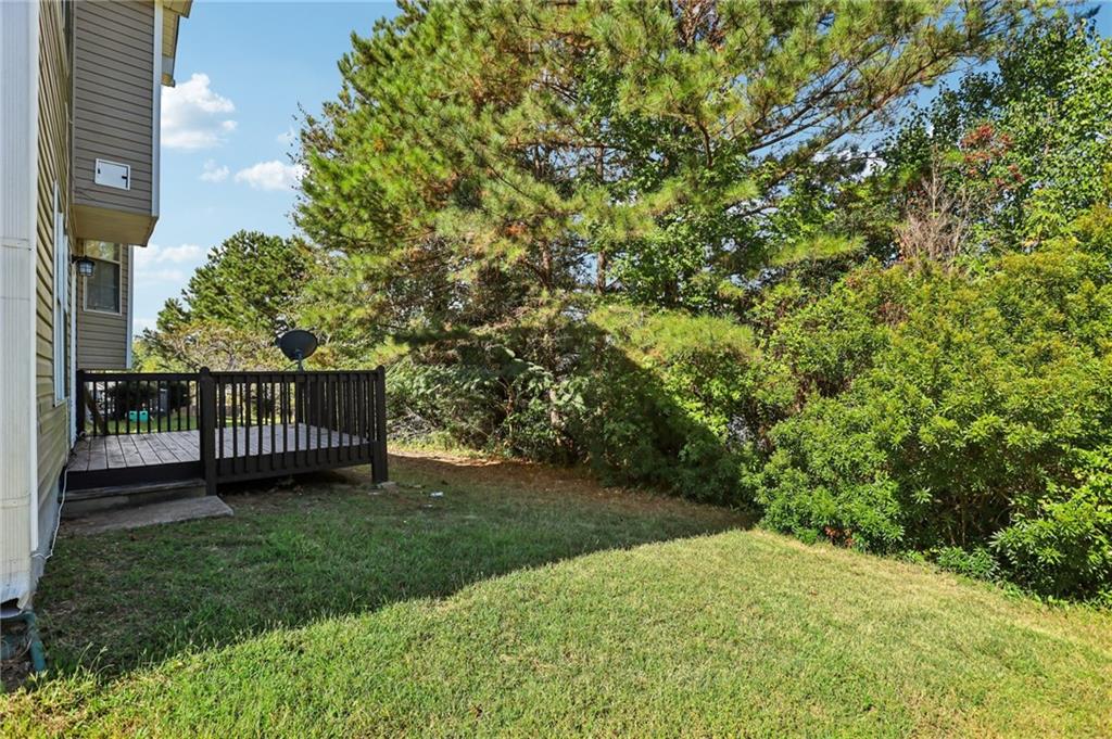 4031 Robin Circle Atlanta, GA 30349 - Photo 20 of 23 a view of a house with a backyard and a garden