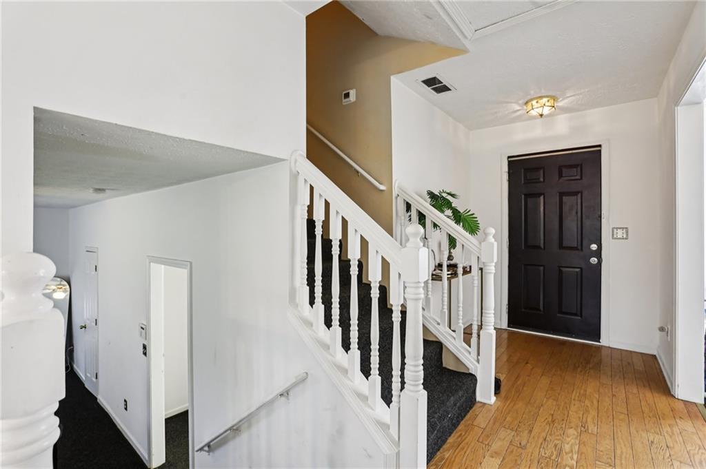 4031 Robin Circle Atlanta, GA 30349 - Photo 2 of 23 a view of hallway with stairs and wooden floor