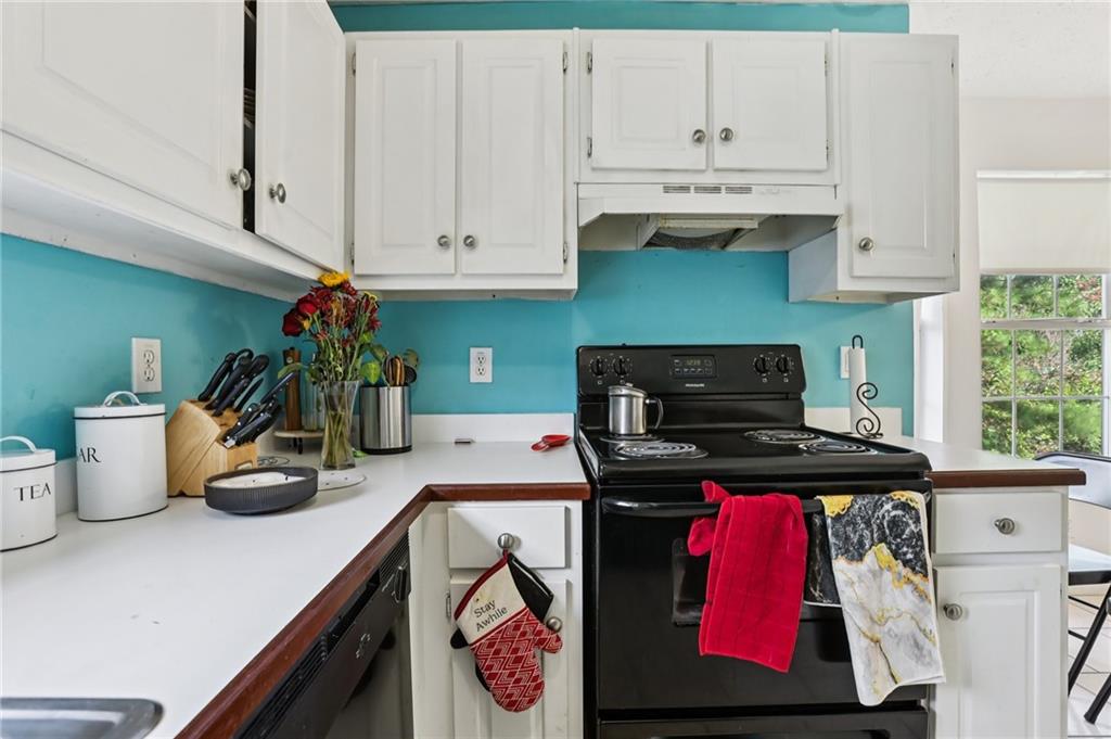 4031 Robin Circle Atlanta, GA 30349 - Photo 6 of 23 a kitchen with a stove and cabinets