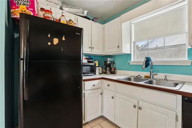 a kitchen with a refrigerator and a sink