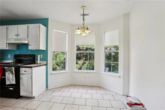 a kitchen with windows and cabinets
