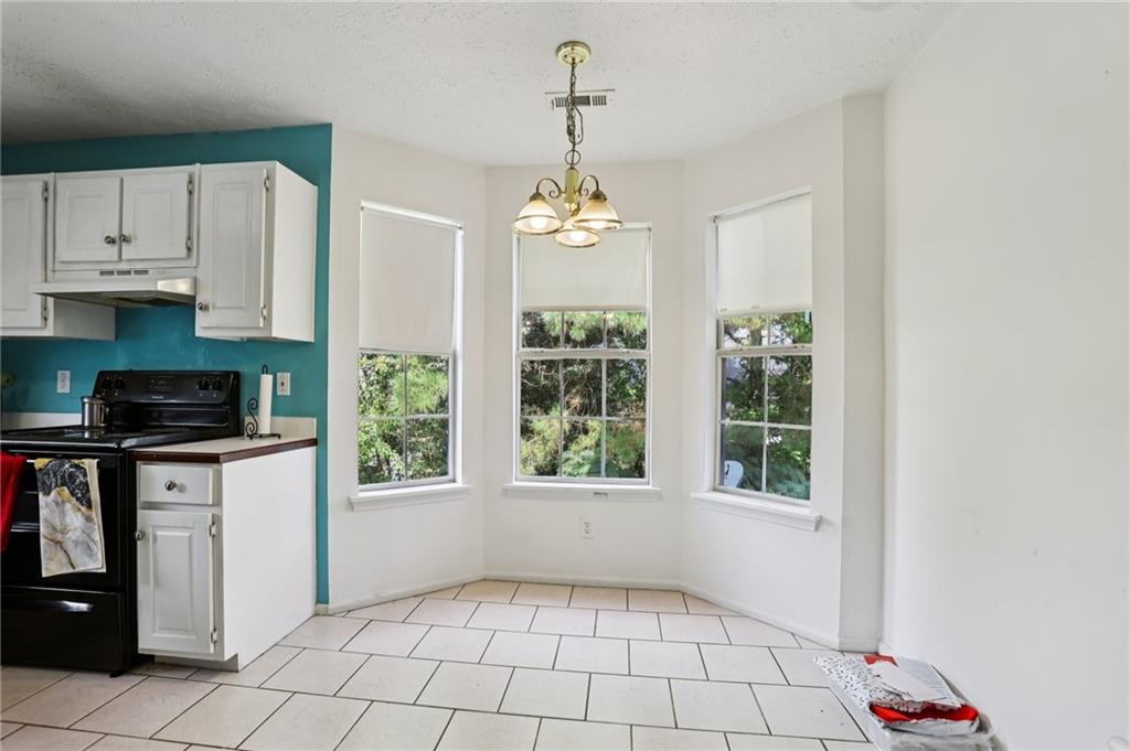 4031 Robin Circle Atlanta, GA 30349 - Photo 8 of 23 a kitchen with windows and cabinets