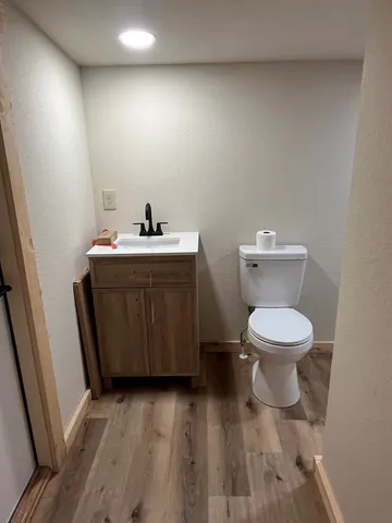 a spacious bathroom with a toilet and a sink