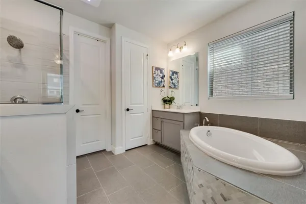 a bathroom with a bathtub and a shower