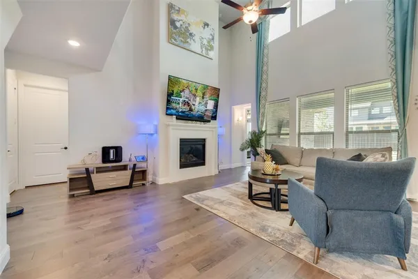 a living room with furniture a fireplace and a flat screen tv