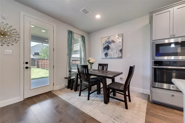 a view of a dining room with furniture window and wooden floor