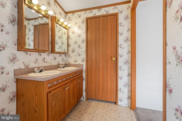 a utility room with a sink and a mirror