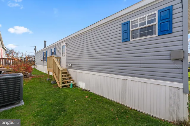 a view of a backyard with stairs and a wooden fence