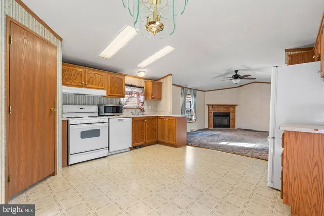 a kitchen with a refrigerator sink and cabinets