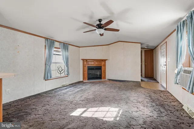 a view of a livingroom with a ceiling fan and window