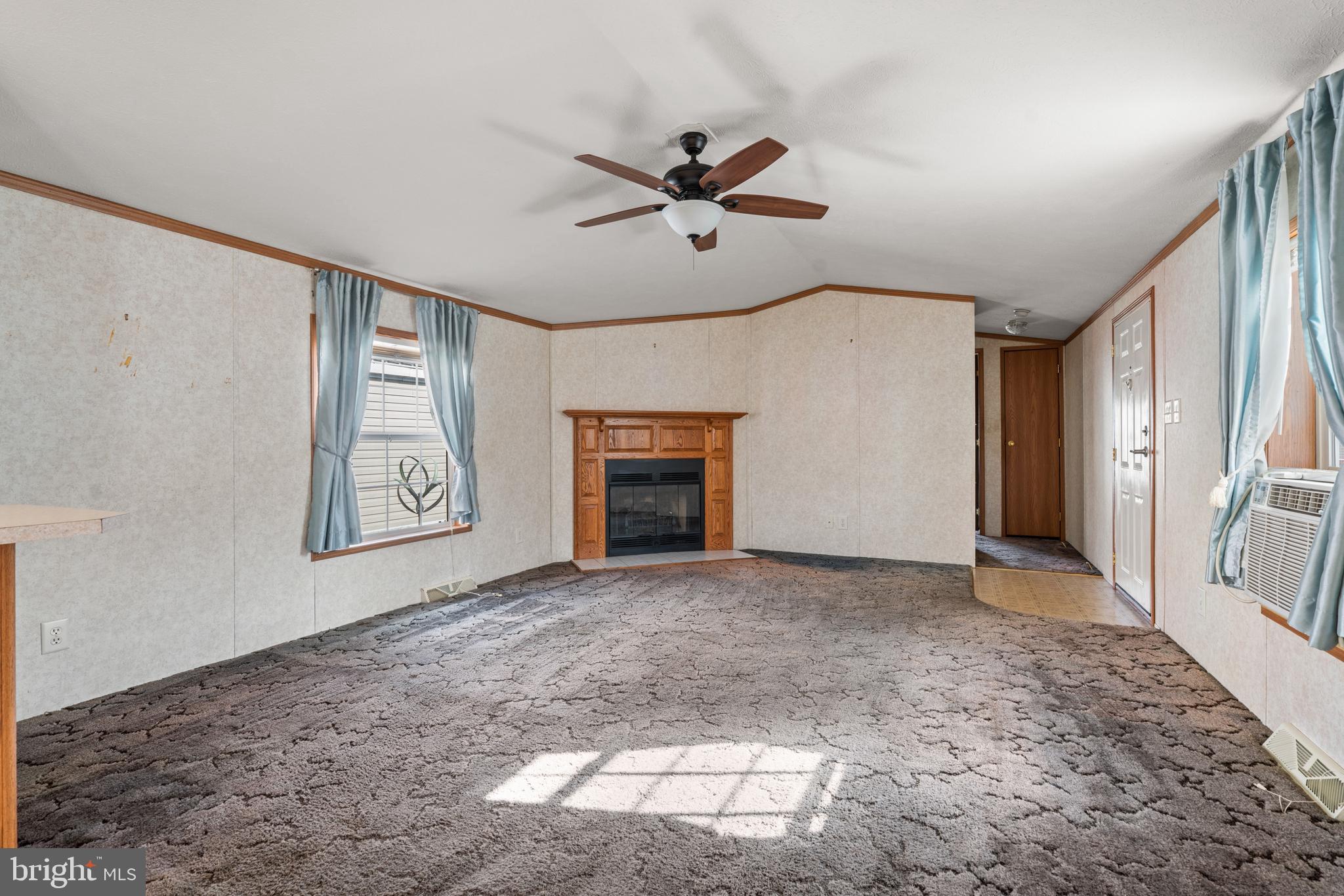523 Canter Road Wilmington, DE 19810 - Photo 7 of 20 a view of a livingroom with a ceiling fan and window