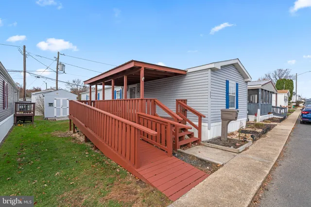 a front view of a house with yard and deck