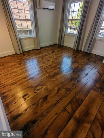 a view of an empty room and wooden floor
