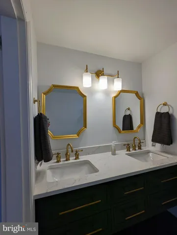 a bathroom with a double vanity sink and a mirror