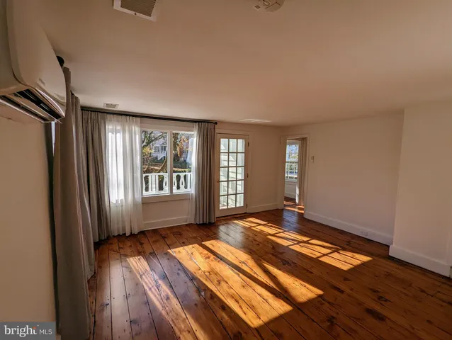a view of a wooden bench next to a yard