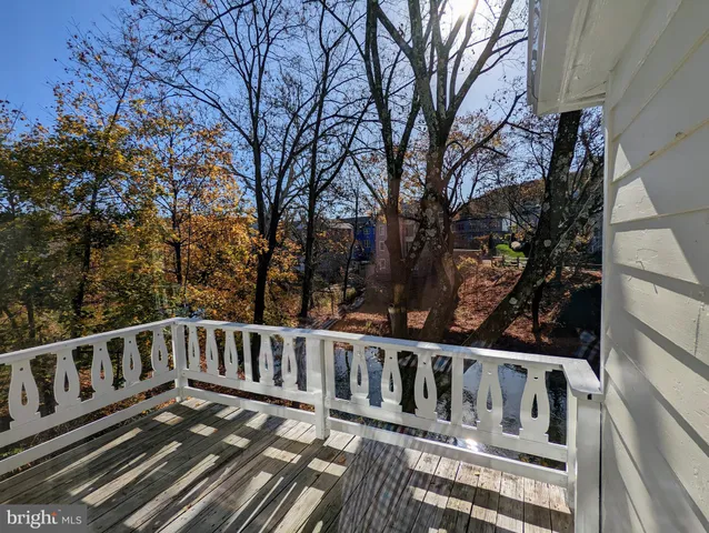 a view of a yard with wooden fence