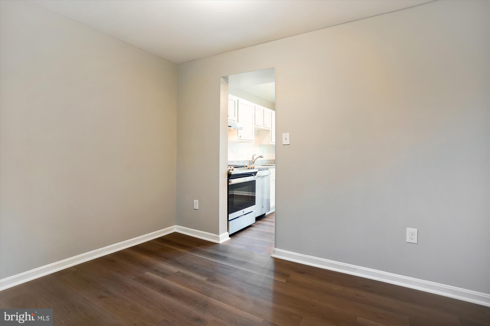 9202 Sprucewood Road Burke, VA 22015 - Photo 9 of 21 a view of an empty room with wooden floor and a window