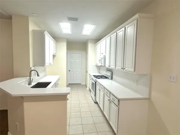 a kitchen with stainless steel appliances granite countertop a sink and a wooden cabinets
