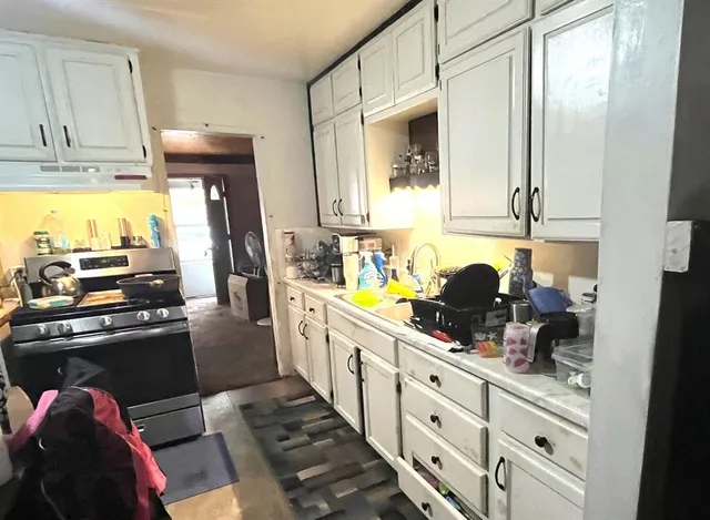 a kitchen with refrigerator and cabinets