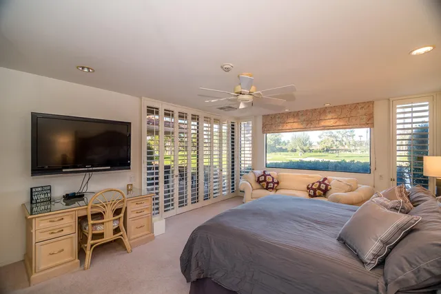 a bed room with a bed and a television