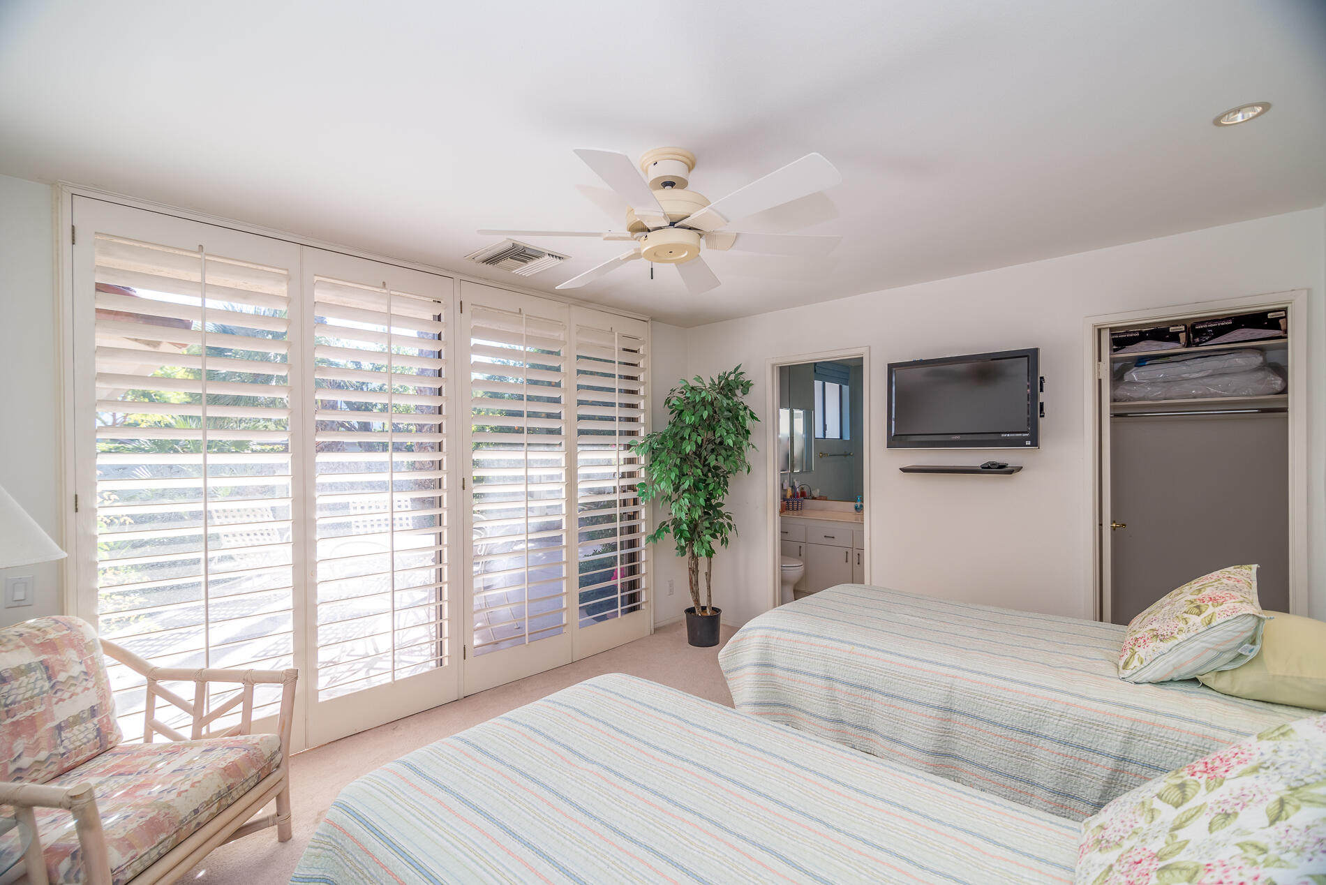 12 Columbia Drive Rancho Mirage, CA 92270 - Photo 21 of 25 a bedroom with a large bed and a chandelier