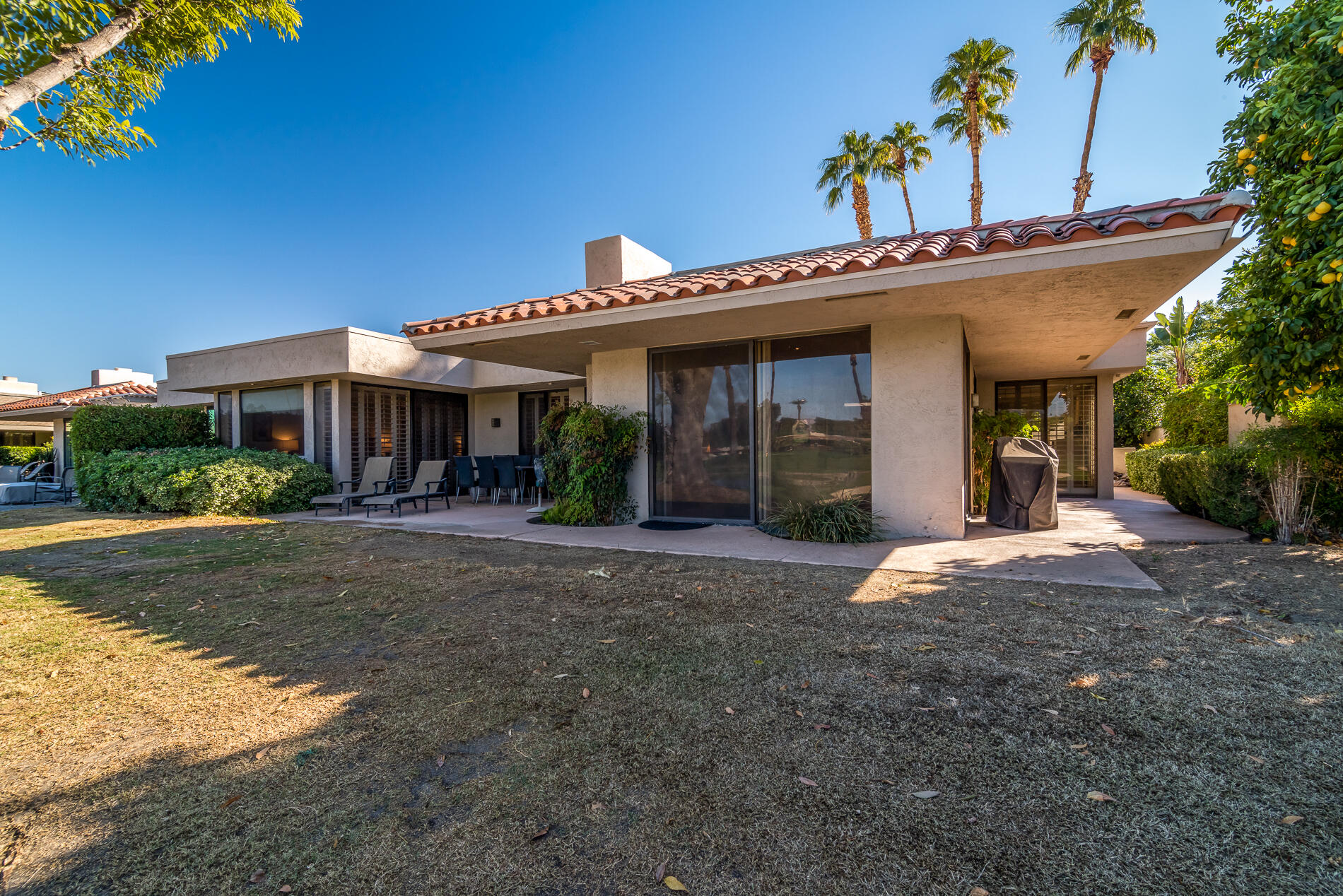 12 Columbia Drive Rancho Mirage, CA 92270 - Photo 23 of 25 a view of a house with a yard and potted plants