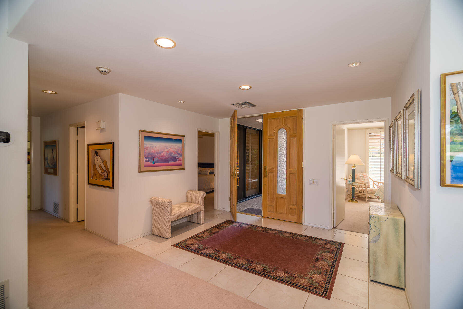 12 Columbia Drive Rancho Mirage, CA 92270 - Photo 8 of 25 a view of a hallway with paintings on the wall