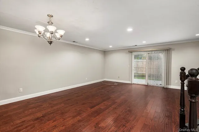 a view of a room with wooden floor fan and windows
