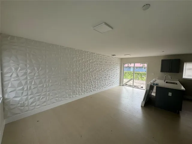 a view of a livingroom with wooden floor and a flat screen tv