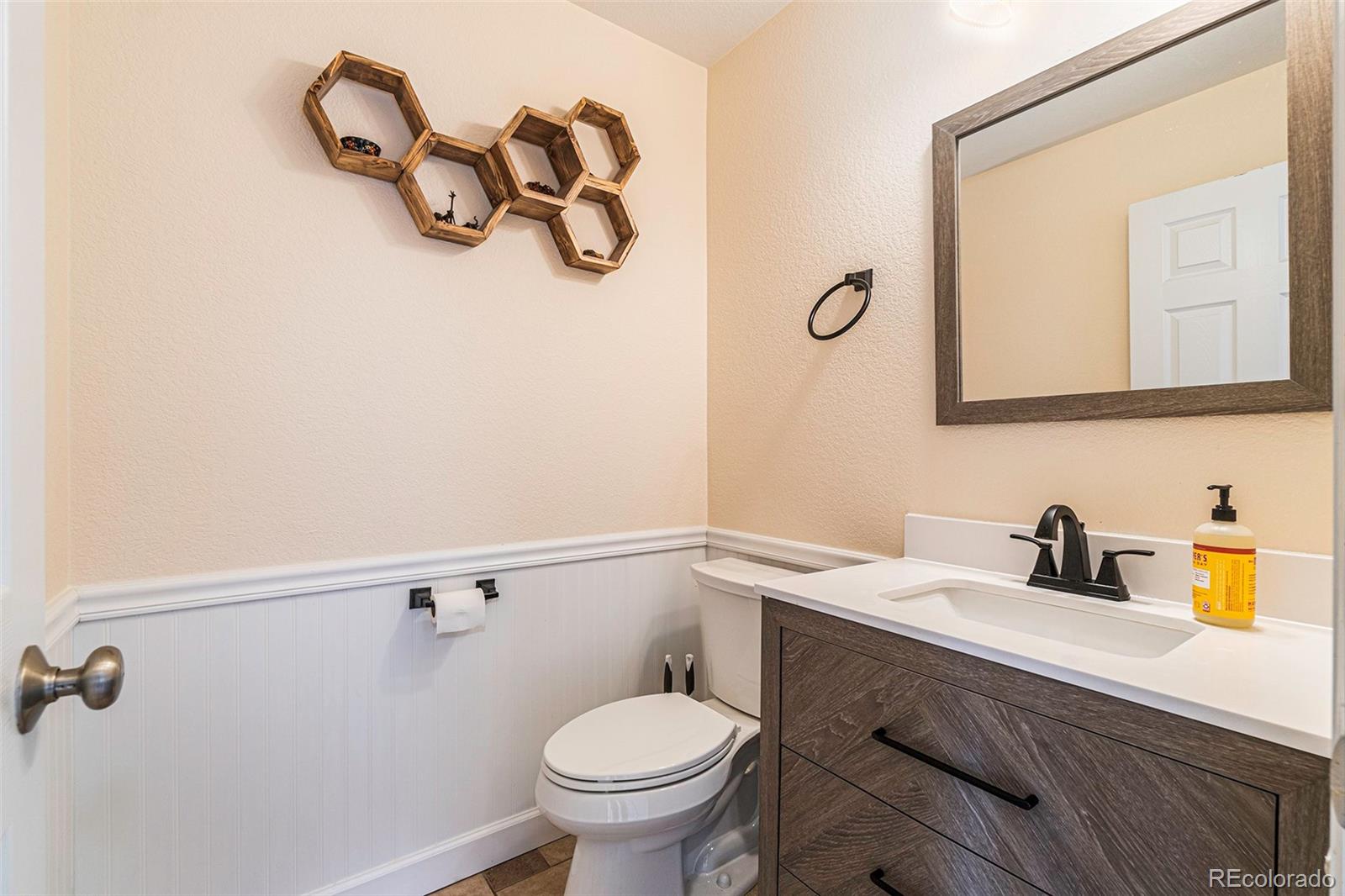 7395 Hickory Circle Frederick, CO 80504 - Photo 11 of 23 a bathroom with a toilet sink and mirror