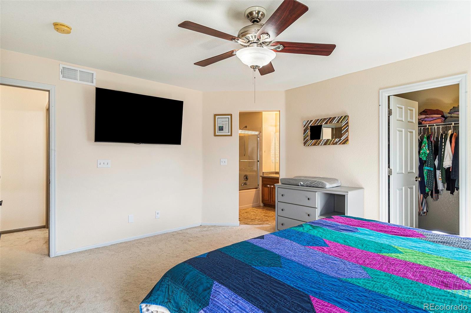 7395 Hickory Circle Frederick, CO 80504 - Photo 19 of 23 a bedroom with a bed and a flat screen tv