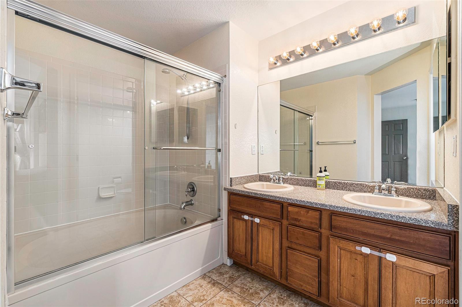 7395 Hickory Circle Frederick, CO 80504 - Photo 21 of 23 a bathroom with a tub a sink and a mirror