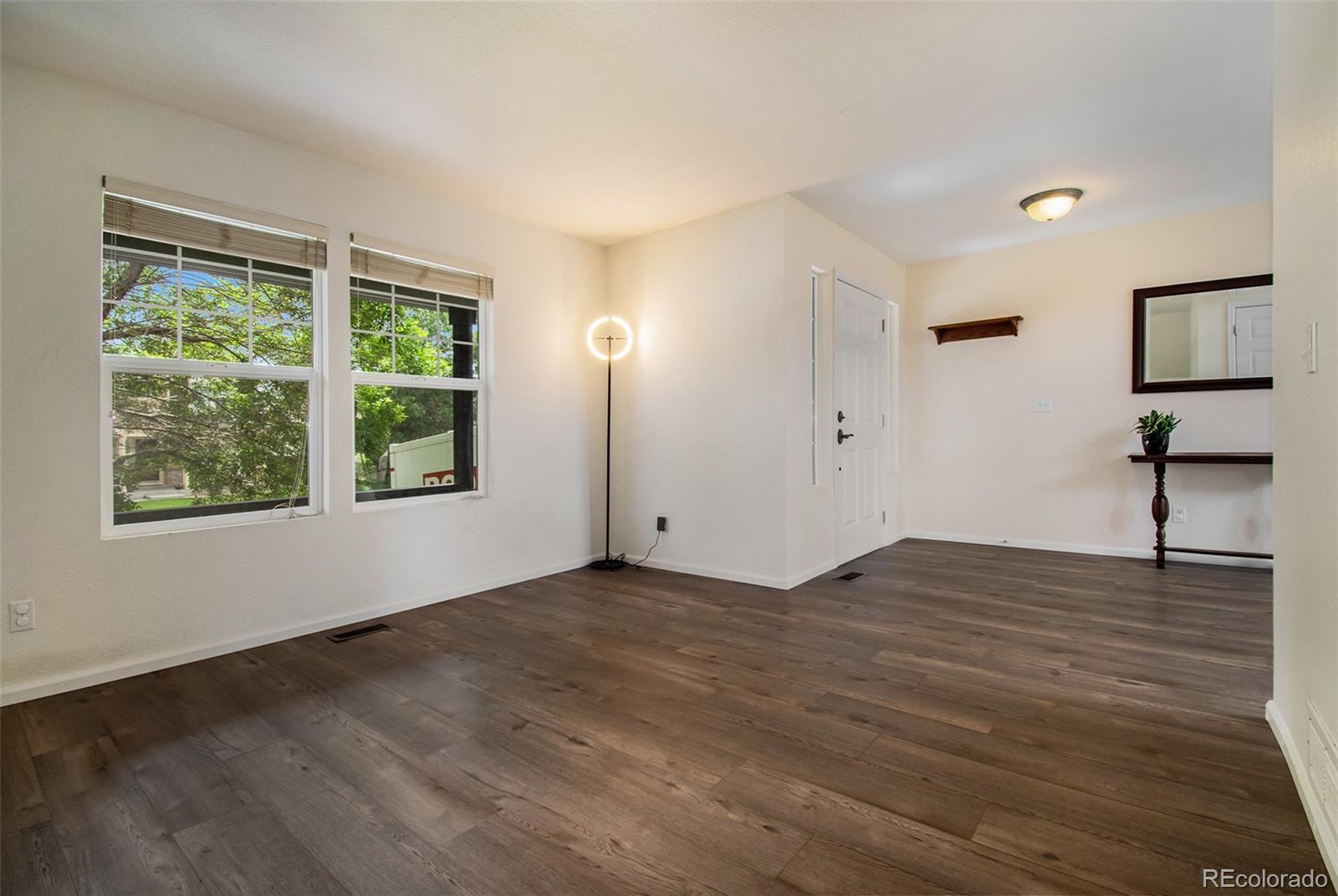 7395 Hickory Circle Frederick, CO 80504 - Photo 4 of 23 a view of an empty room with wooden floor and a window