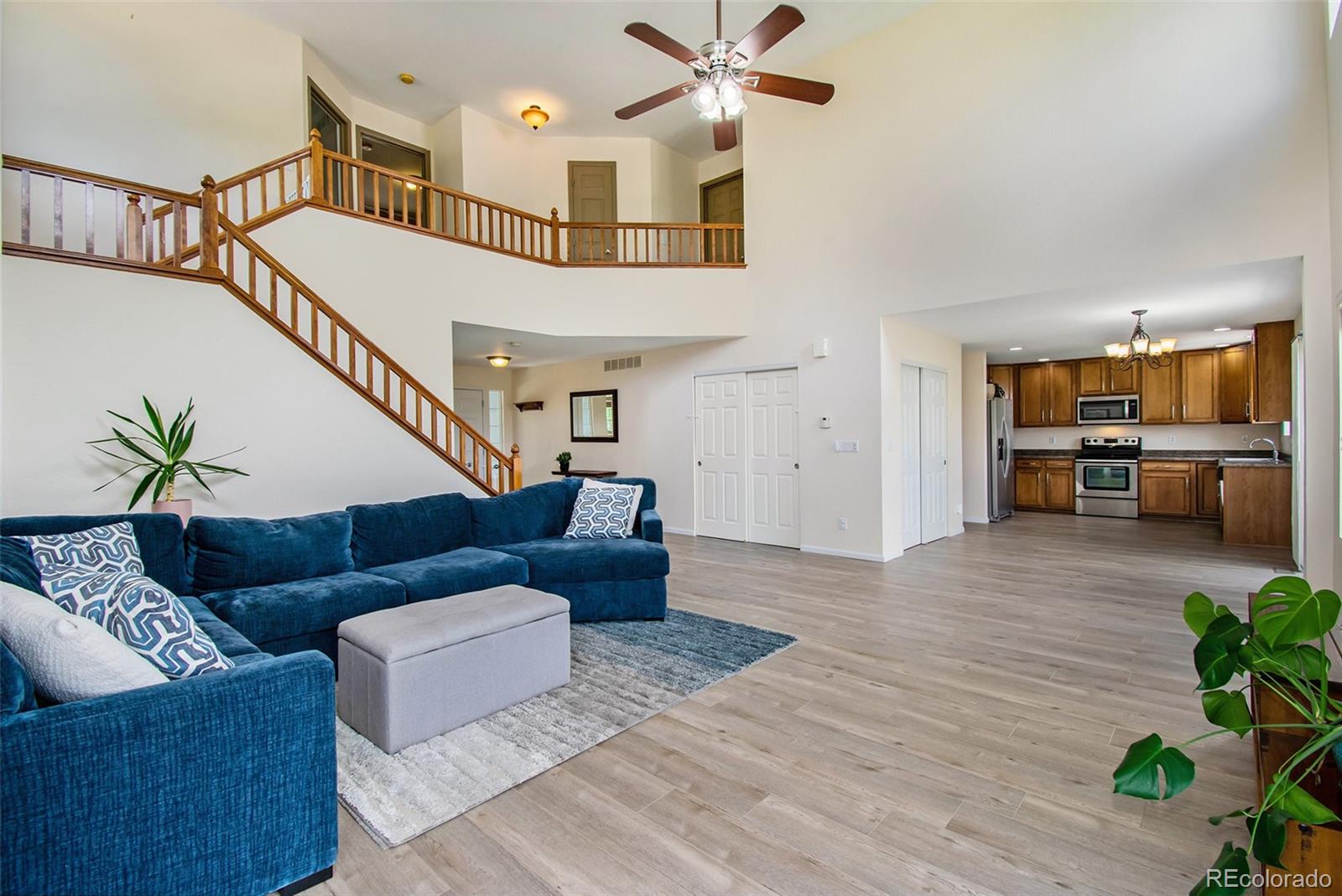 7395 Hickory Circle Frederick, CO 80504 - Photo 6 of 23 a living room with furniture and a chandelier