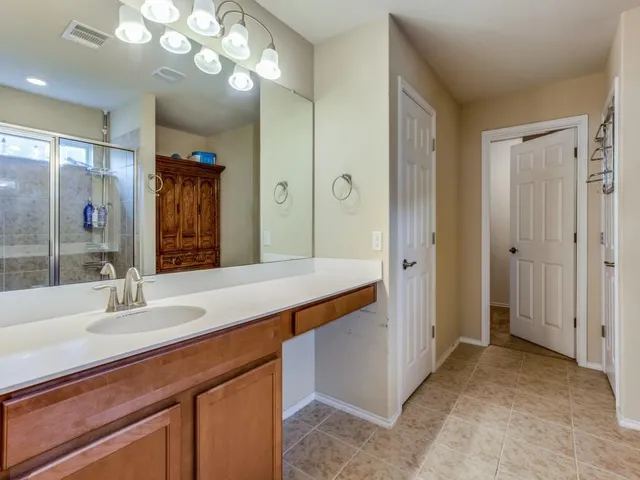 a bathroom with a sink double vanity and a mirror