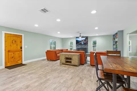 a dining room with furniture and wooden floor