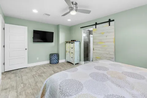 a bedroom with furniture and a flat screen tv