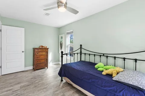 a bedroom with furniture and wooden floor