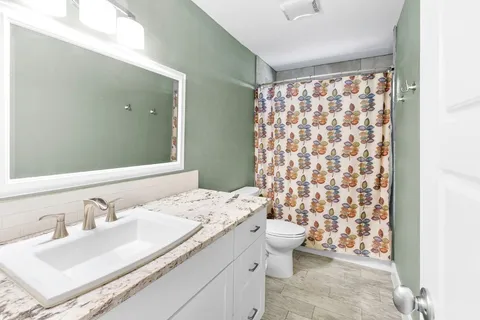 a bathroom with a sink toilet and shower