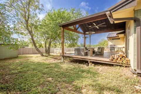 a view of a patio with a table and chairs under an umbrella