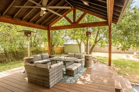 a view of living room with patio furniture and wooden floor