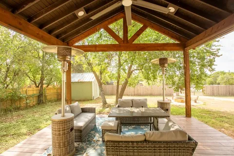 a living room with fireplace furniture and a large window