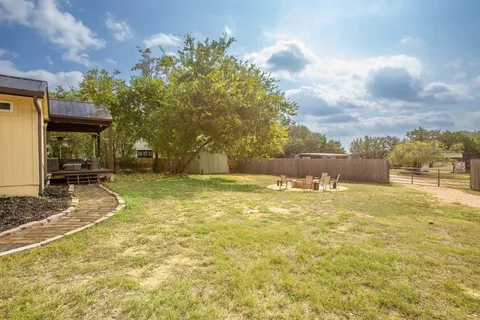 a view of yard and swimming pool
