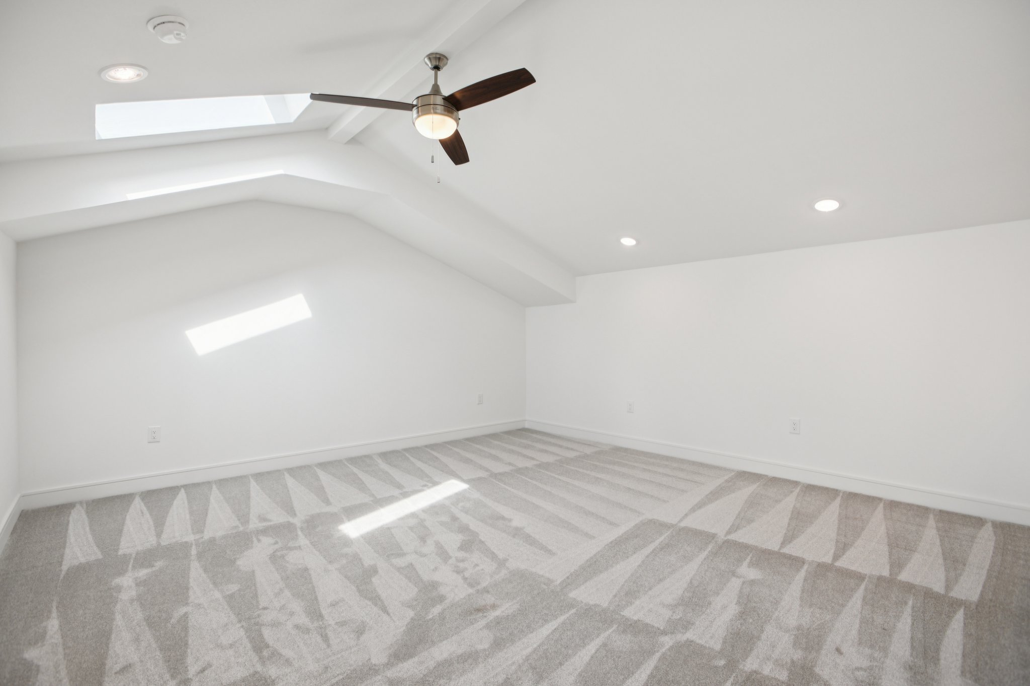 202 Tesla Circle Austin, TX 78681 - Photo 34 of 35 Bonus room with a skylight, light carpet, a ceiling fan, and beam ceiling