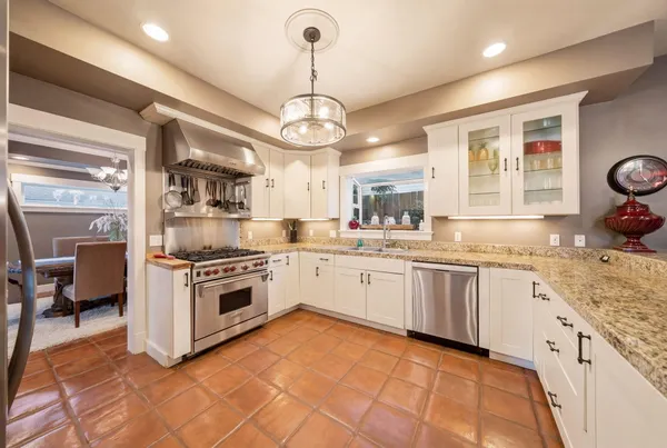 a spacious bathroom with a granite countertop sink mirror and a bath tub