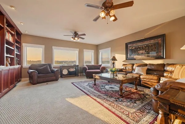 a living room with furniture and book shelf