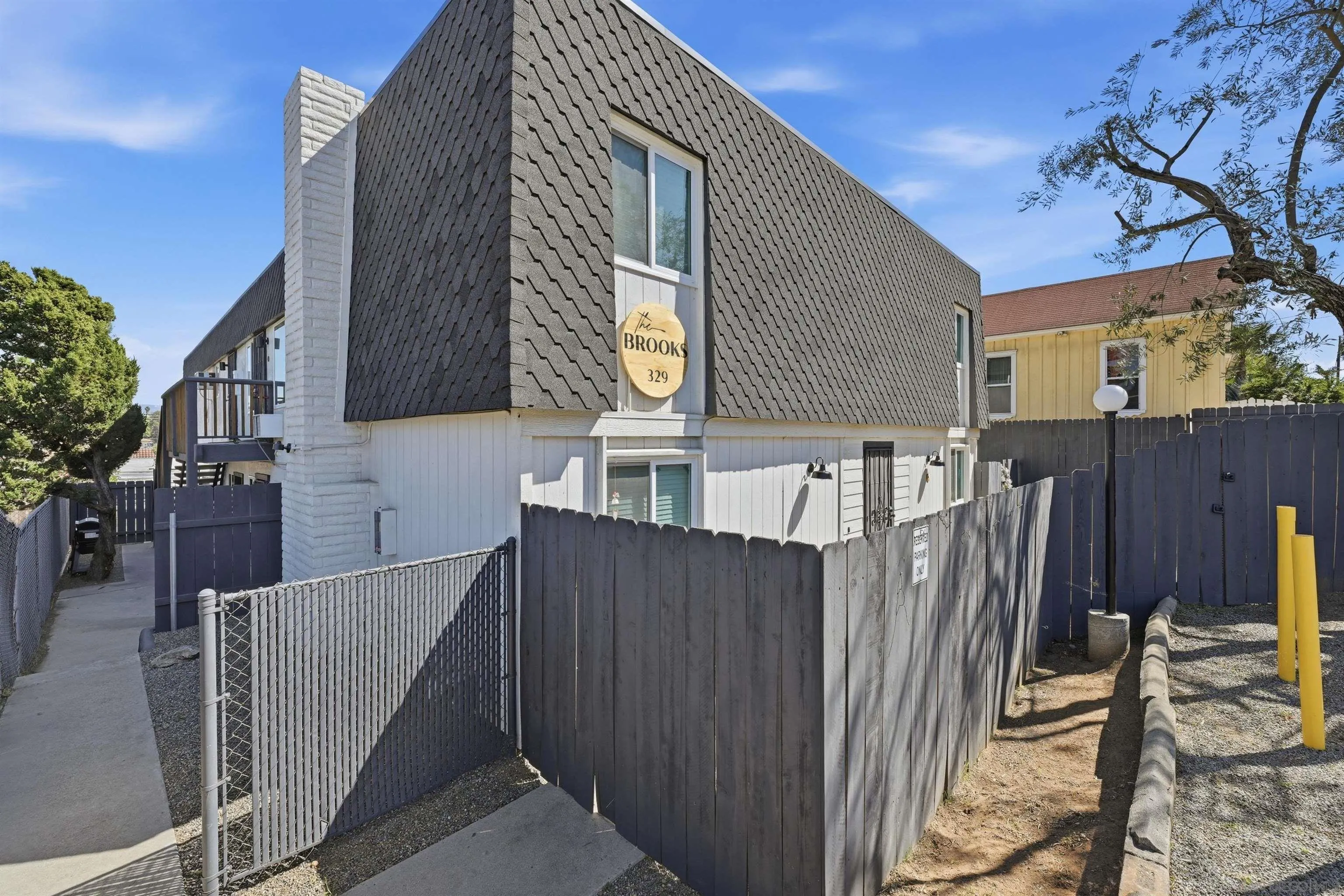 a view of a house with wooden fence